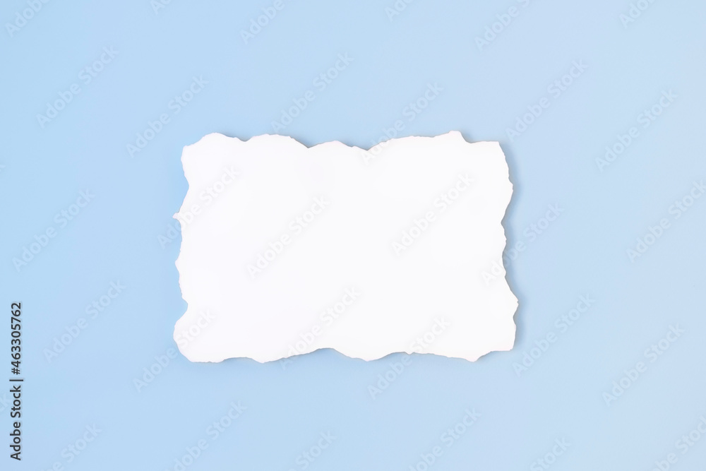 White empty blank paper with uneven border on light blue background. Invitation card mockup on soft blue table. Flat lay, top view, copy space, mockup