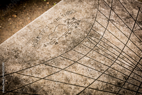 Close-Up of an Antique Concrete Sundial in a Formal Garden