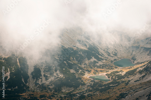 Stunning view from Musala summit at Rila glacier lakes on a misty, foggy, moody day and a sift light © Nikola
