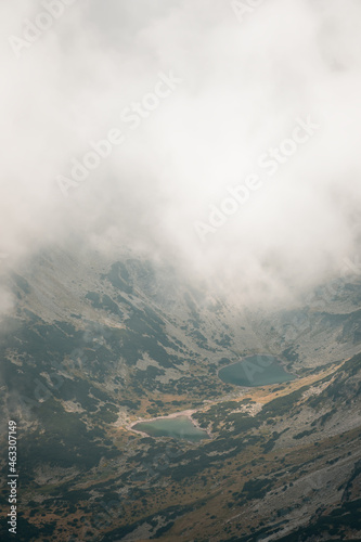 Stunning view from Musala summit at Rila glacier lakes on a misty, foggy, moody day and a sift light