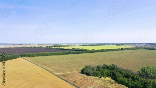 Aerial photography of agricultural fields in Russia. Beautiful views. Sunny day.