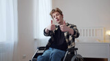 A handsome disabled man is showing a thumb-up