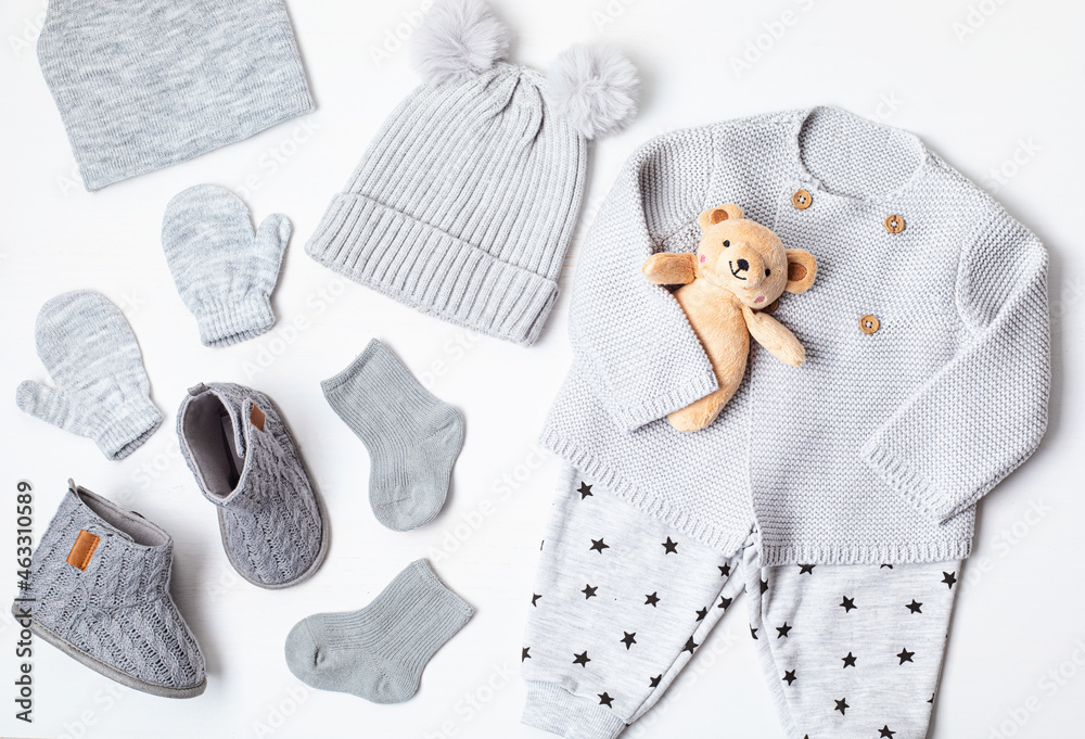 Collection of cute organic baby clothes and booties. Warm gender neutral  outfit for cold weather of fall and winter season. Newborn gifts, baby  shower, second hand clothes, donation idea. Photos | Adobe