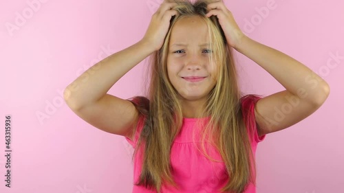 Girl scratches her head on a colored background