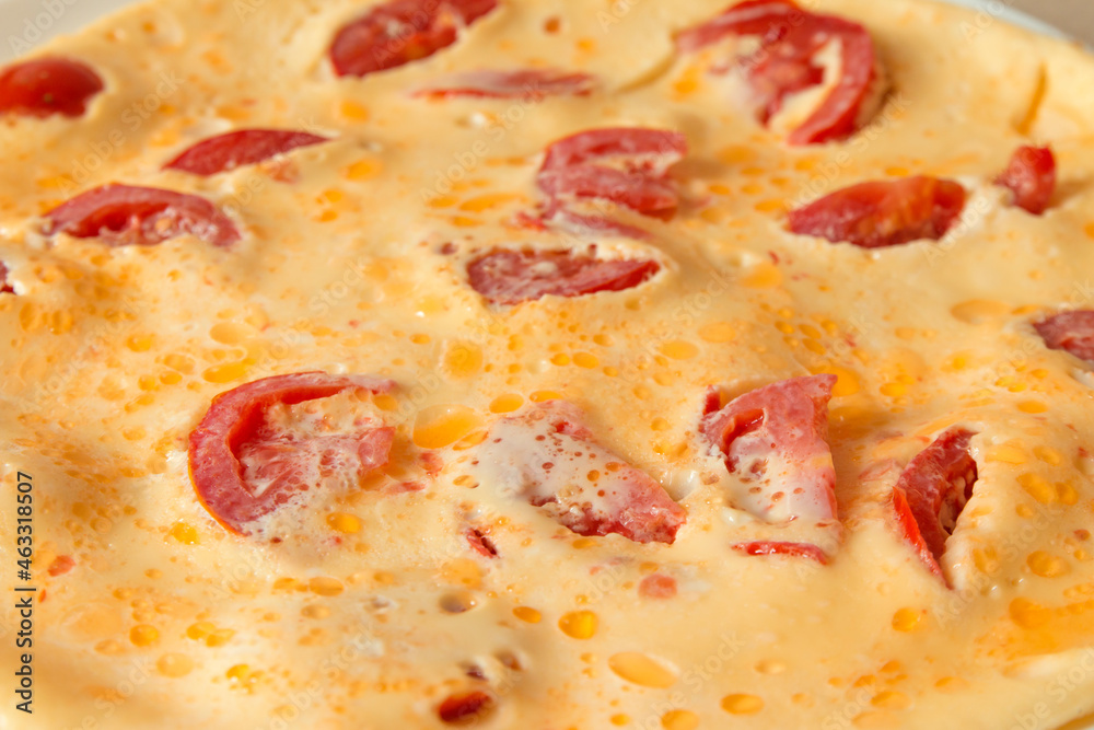 Omelet with sliced tomatoes on the plate. Scrambled eggs top view. Healthy breakfast and lunch, selective focus Omelet with sliced tomatoes on the plate. Scrambled eggs top view. Healthy breakfast and lunch, selective focus