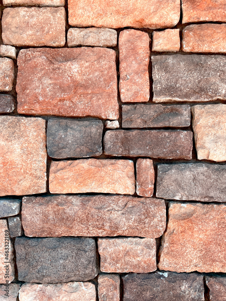 red color carved stone brick wall close up view with deep shadows red color carved stone brick wall close up view with deep shadows