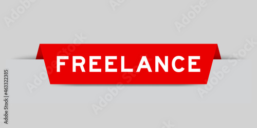 Red color inserted label with word freelance on gray background