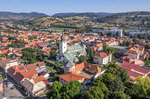Aerial panoramic view of Krupina small medieval town in Southern Slovakia with traces of medieval city wall between modern block houses and old buildings, bastion turned outdoor movie theater cinema