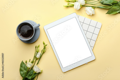 Cup of coffee  tablet computer  notebook and flowers on color background