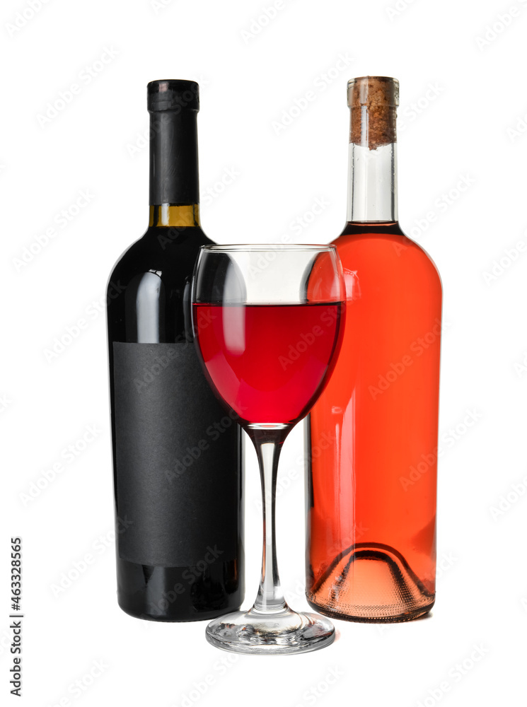 Glass and bottles of delicious red wine on white background