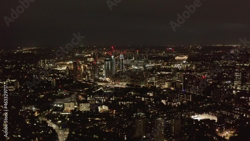 Wallpaper Mural Aerial panoramic view of large city at night. City lights glowing into dark. Fly above urban neighbourhood. London, UK Torontodigital.ca