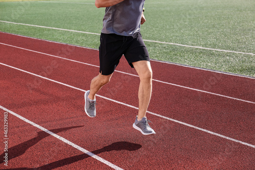 Sporty mature man running at stadium © Pixel-Shot