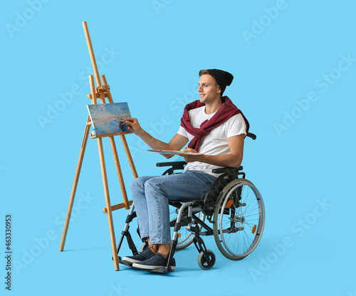 Wallpaper Mural Young male artist in wheelchair painting picture against color background Torontodigital.ca