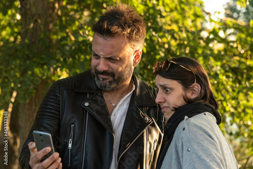 Принти на полотні two guys watching a post on smartphone and making a cringe expression