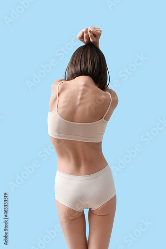 Young skinny woman on color...