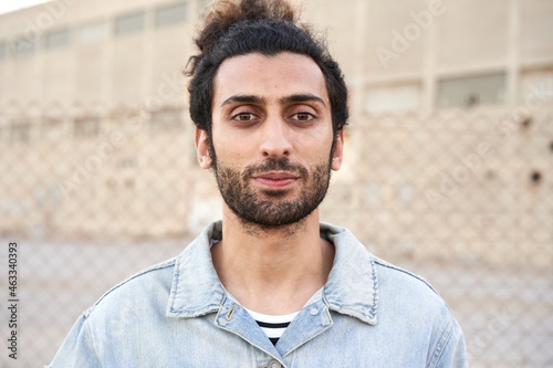 Portrait of a serious muslim young man looking at camera.