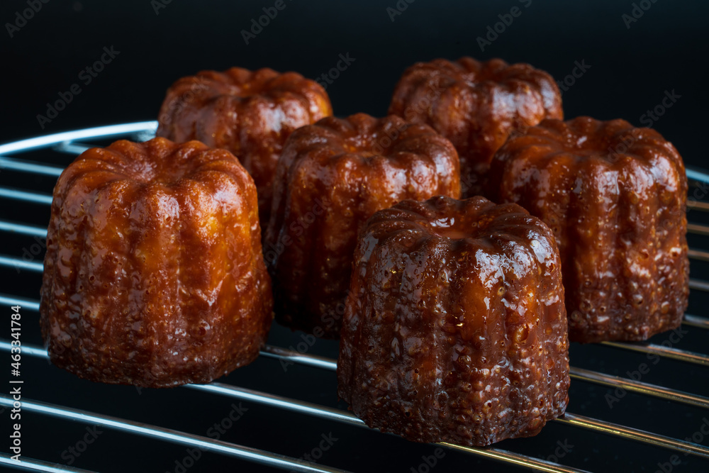 Close up image of canelé with black background Close up image of canelé with black background