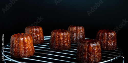 Close up image of  canelé with black background photo