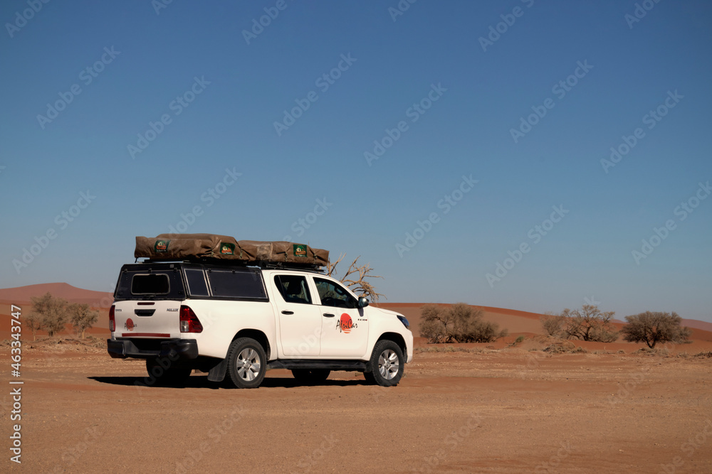 Toyota Hilux stands in the golden sands of the Namib desert. 17.10.2021 ...