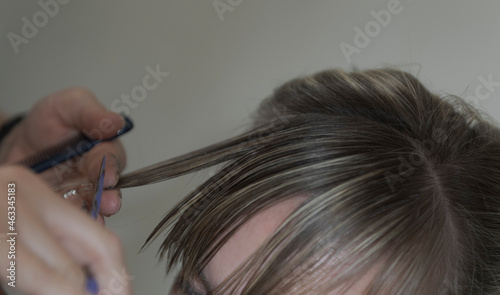 Women's haircut process. Close-up