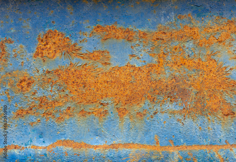 A rusty blue metal wall with fallen paint, a rusty background.