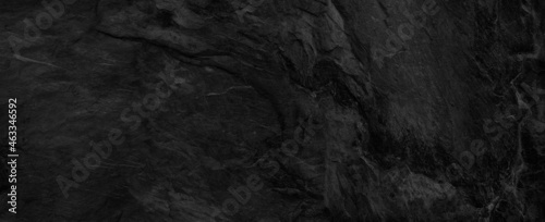 Panorama dark gray stone background with copy space. Black grunge banner with rock texture.