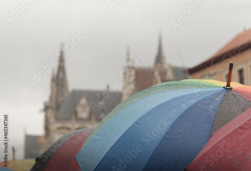 Fototapeta Naklejka Na Ścianę i Meble -  Excursion in bad weather along the canals of the ancient city. Multi-colored umbrellas. Copy space