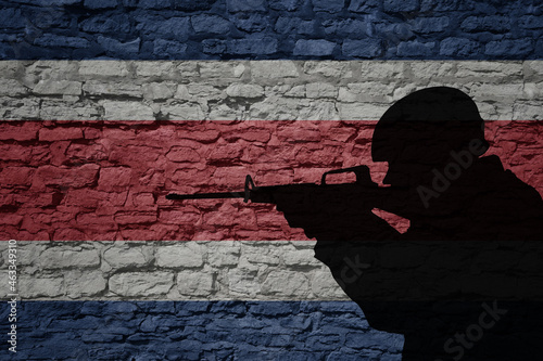 Soldier silhouette on the old brick wall with flag of costa rica country.