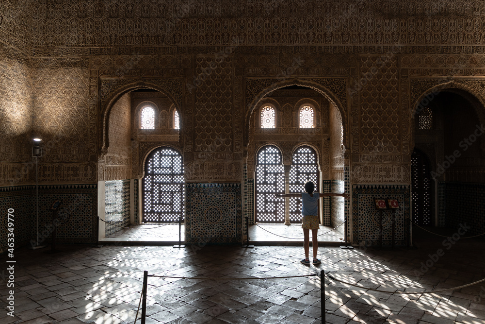 Girl enjoying the light of the Alhambra in Granada. - obrazy, fototapety, plakaty 