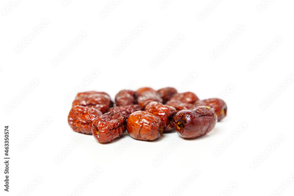 Dried Chinese dates isolated on white background. Close up of dried Chinese red dates or jujube. Selective focus. Dried Chinese dates isolated on white background. Close up of dried Chinese red dates or jujube. Selective focus.