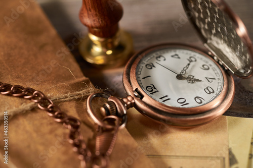 Ancient watch on a wooden background, close-up
