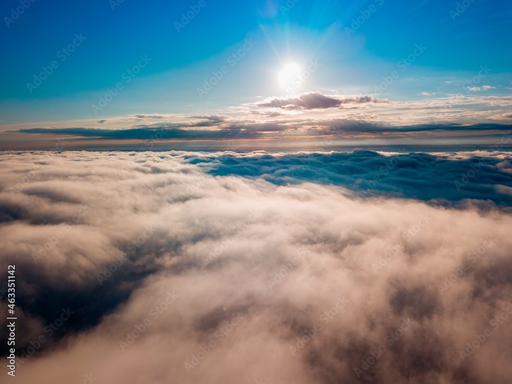 High flight over the fog in the mountains. Ukrainian Carpathians in the morning. Aerial drone view.