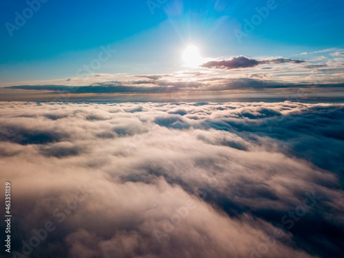 High flight over the fog in the mountains. Ukrainian Carpathians in the morning. Aerial drone view.