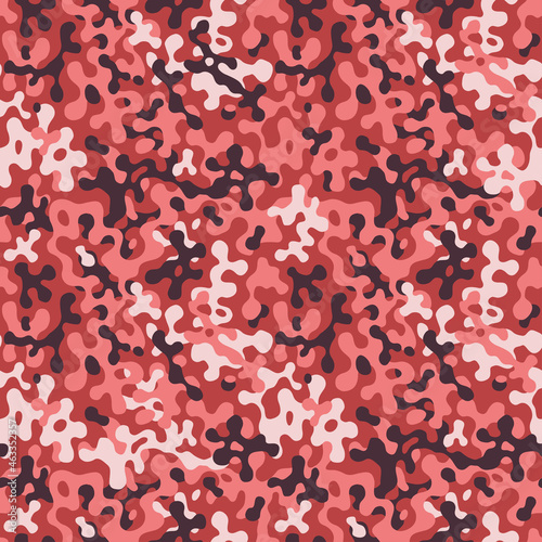 Fashionable pink and crimson color camouflage pattern. Military fabric design. Seamless  background, masking clothing, red camo repeat print. Vector wallpaper.