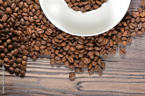 White coffee mug filled with coffee beans © Евгений Порохин