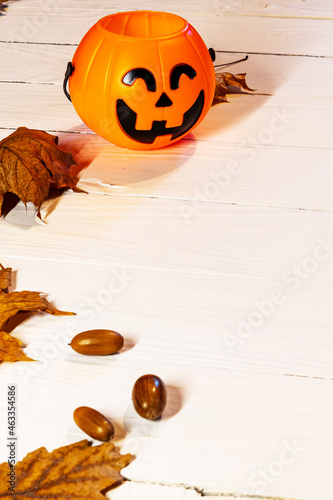 Scary, sinister Halloween Jack Lantern, close-up with a grin on a white table