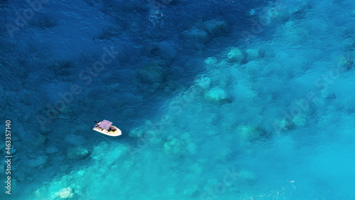 Aerial drone view of moored boat near the coast of Zakynthos, Greece © frimufilms