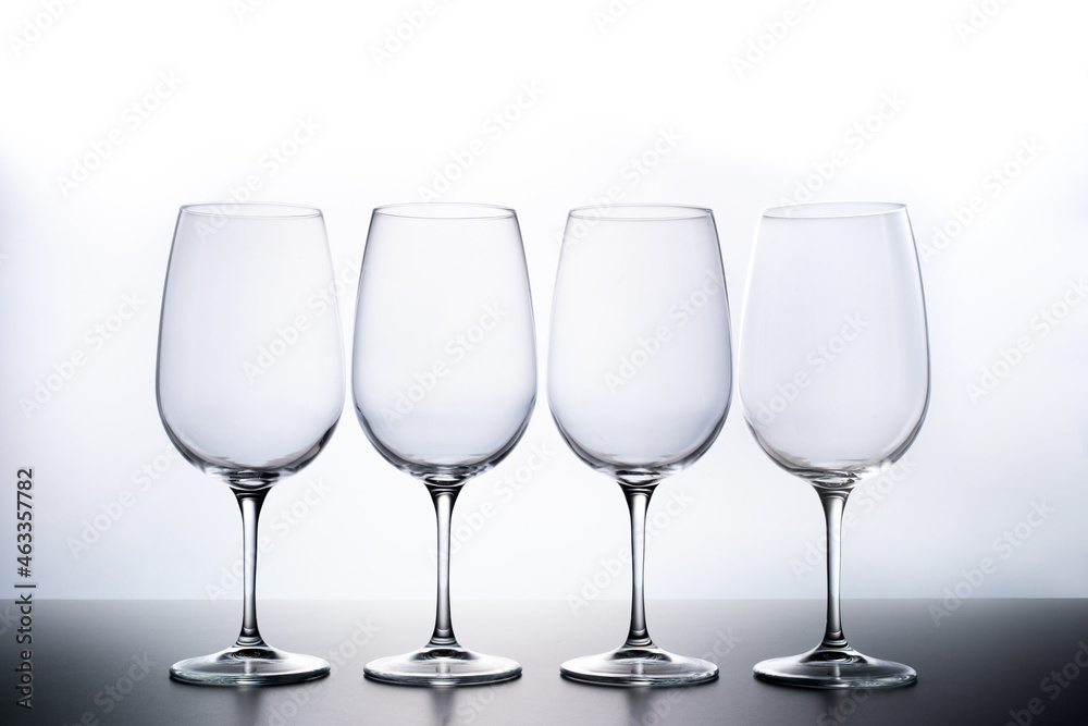 Empty red wine glasses on gradient white background