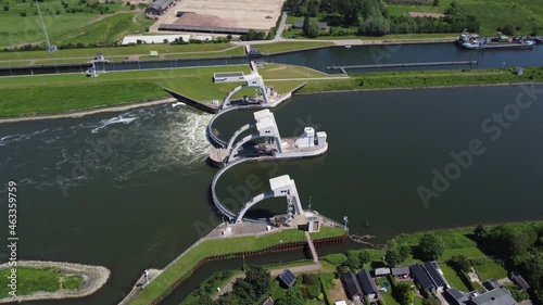 High altitude aerial view of modern water channel controller controlled at both sides by a gate or lock these gates commonly control levels and flow rates in rivers and canals 4k drone footage photo