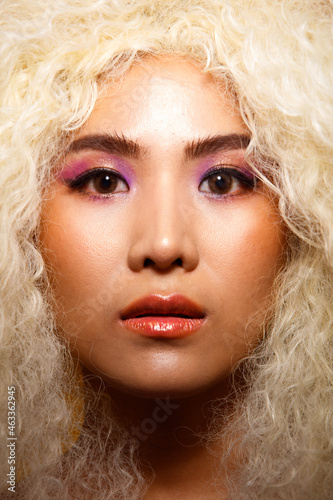 Half Body Portrait of 20s Asian Caucasian beautiful Woman blonde afro hair high fashion make up