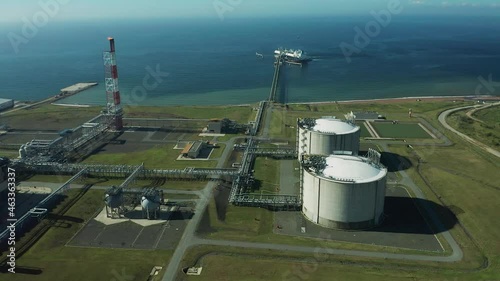 On a summer day, huge tankers are refueled with gas in the south of Sakhalin Island from an LNG plant for transportation to other countries.