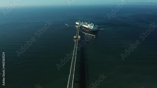 On a summer day, huge tankers are refueled with gas in the south of Sakhalin Island from an LNG plant for transportation to other countries.