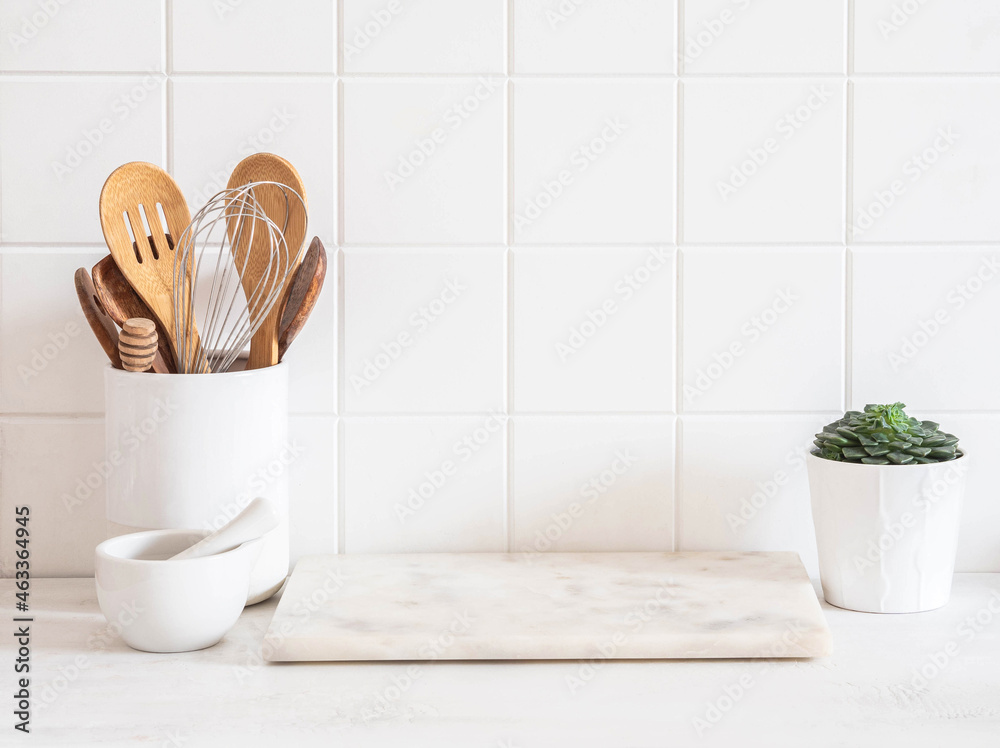 Kitchen with white stone countertops, solid wood cabinets, and vintage tile  on the walls Stock Photo - Alamy