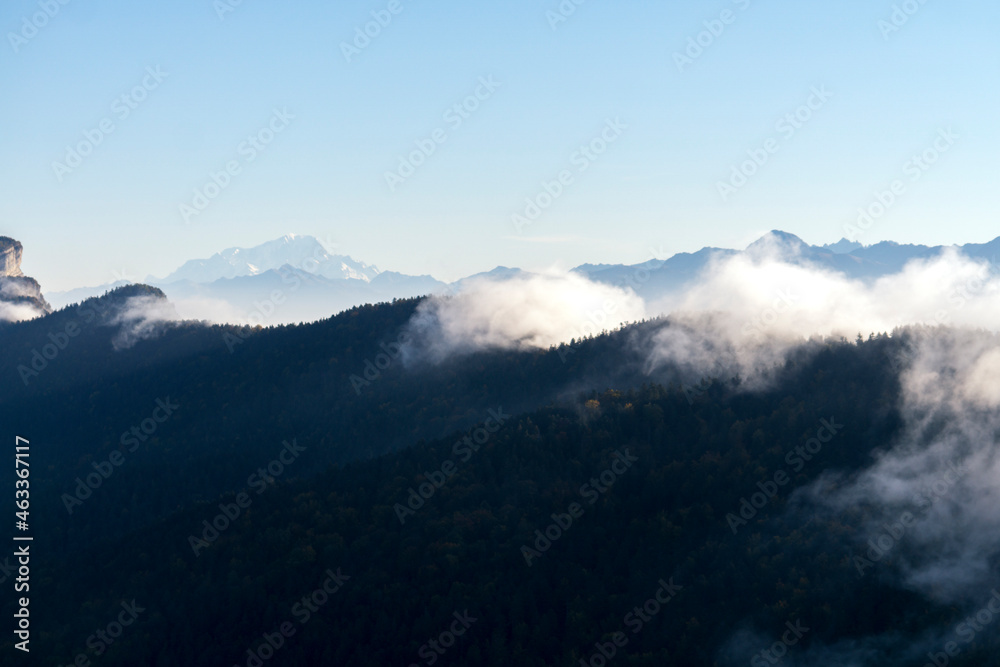 Clouds passing above a crest and Mont Blanc in the background Clouds passing above a crest and Mont Blanc in the background