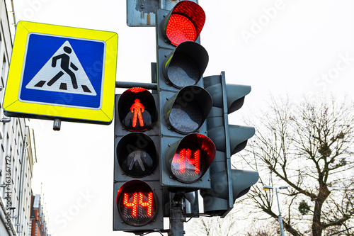 Traffic light and pedestrian crossing sign, close-up, daytime, cold season