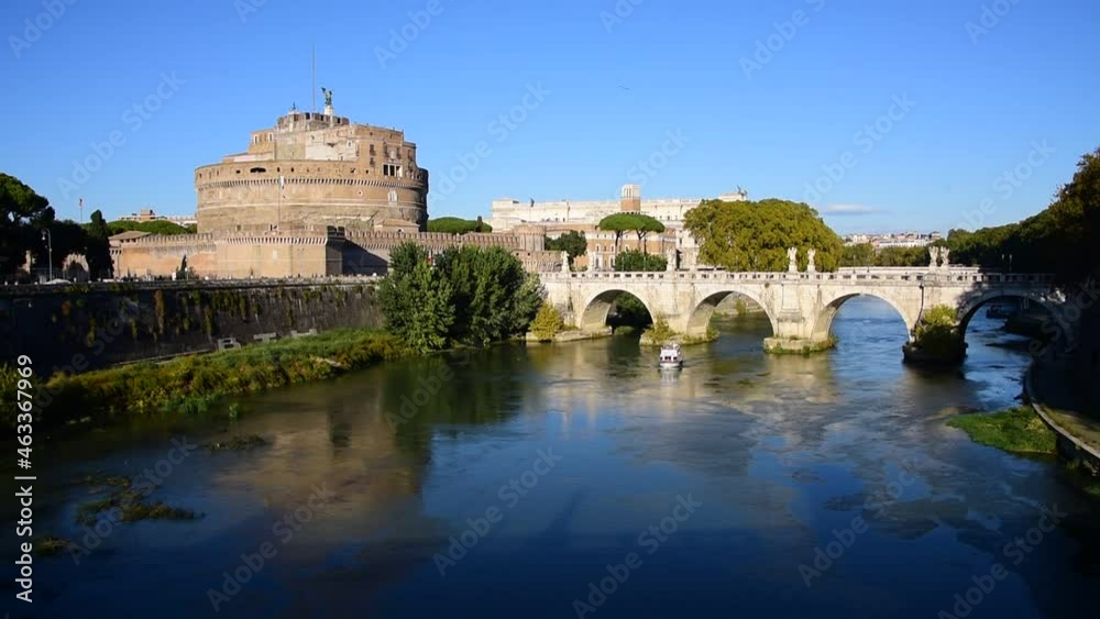 ROME - OCTOBER 13, 2021: Panoramic view of Saint Angel Castle and Saint Angel Bridge with a tourist boat sailing on Tiber river during sunny afternoon - HD, 60 fps ROME - OCTOBER 13, 2021: Panoramic view of Saint Angel Castle and Saint Angel Bridge with a tourist boat sailing on Tiber river during sunny afternoon - HD, 60 fps