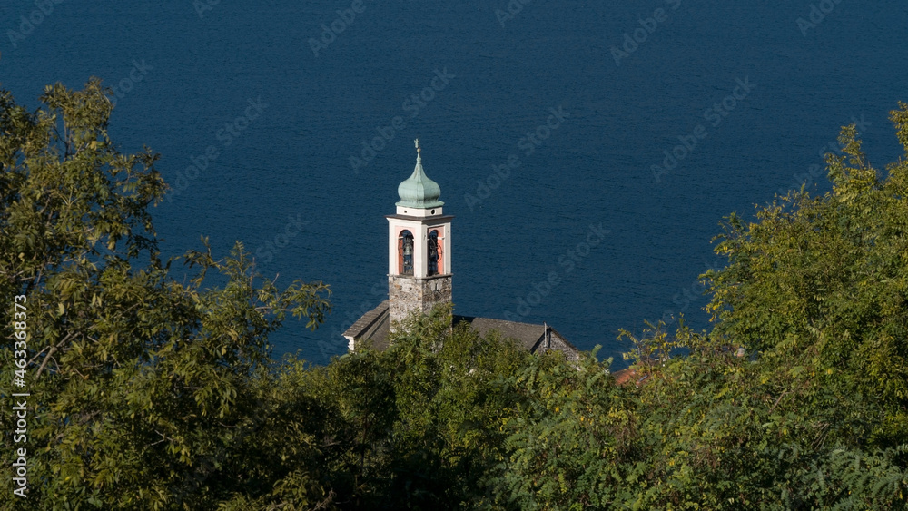 View from above of a church tower on the lake shore View from above of a church tower on the lake shore
