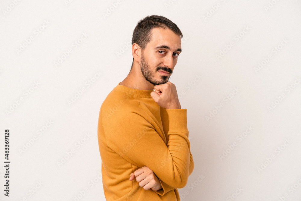 Young caucasian man isolated on white background smiling happy and confident, touching chin with hand. Young caucasian man isolated on white background smiling happy and confident, touching chin with hand.