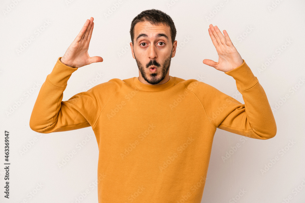 Young caucasian man isolated on white background celebrating a victory or success, he is surprised and shocked. Young caucasian man isolated on white background celebrating a victory or success, he is surprised and shocked.