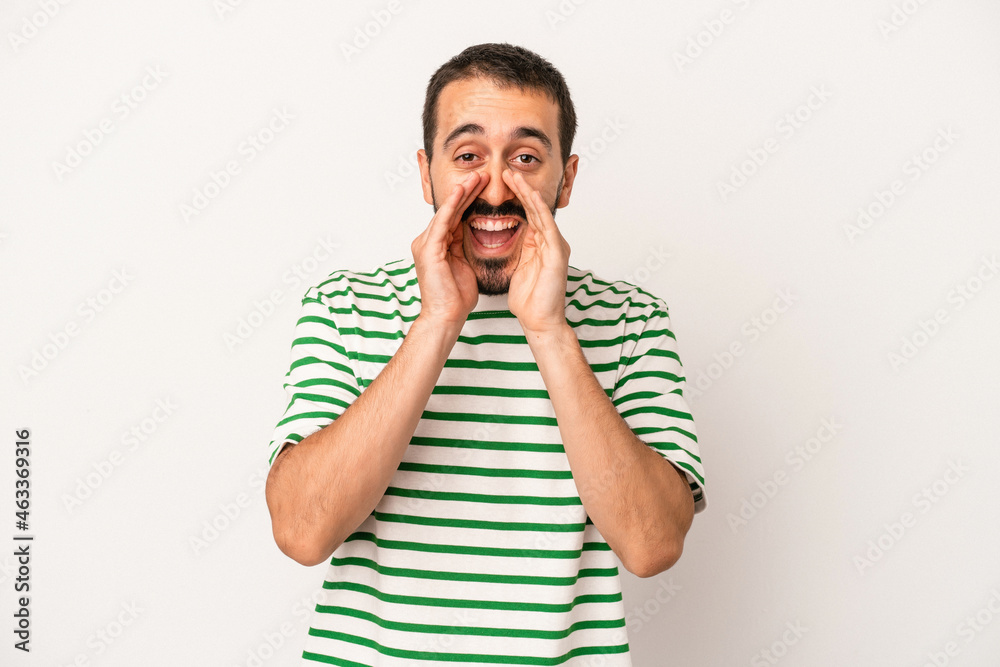 Young caucasian man isolated on white background saying a gossip, pointing to side reporting something. Young caucasian man isolated on white background saying a gossip, pointing to side reporting something.